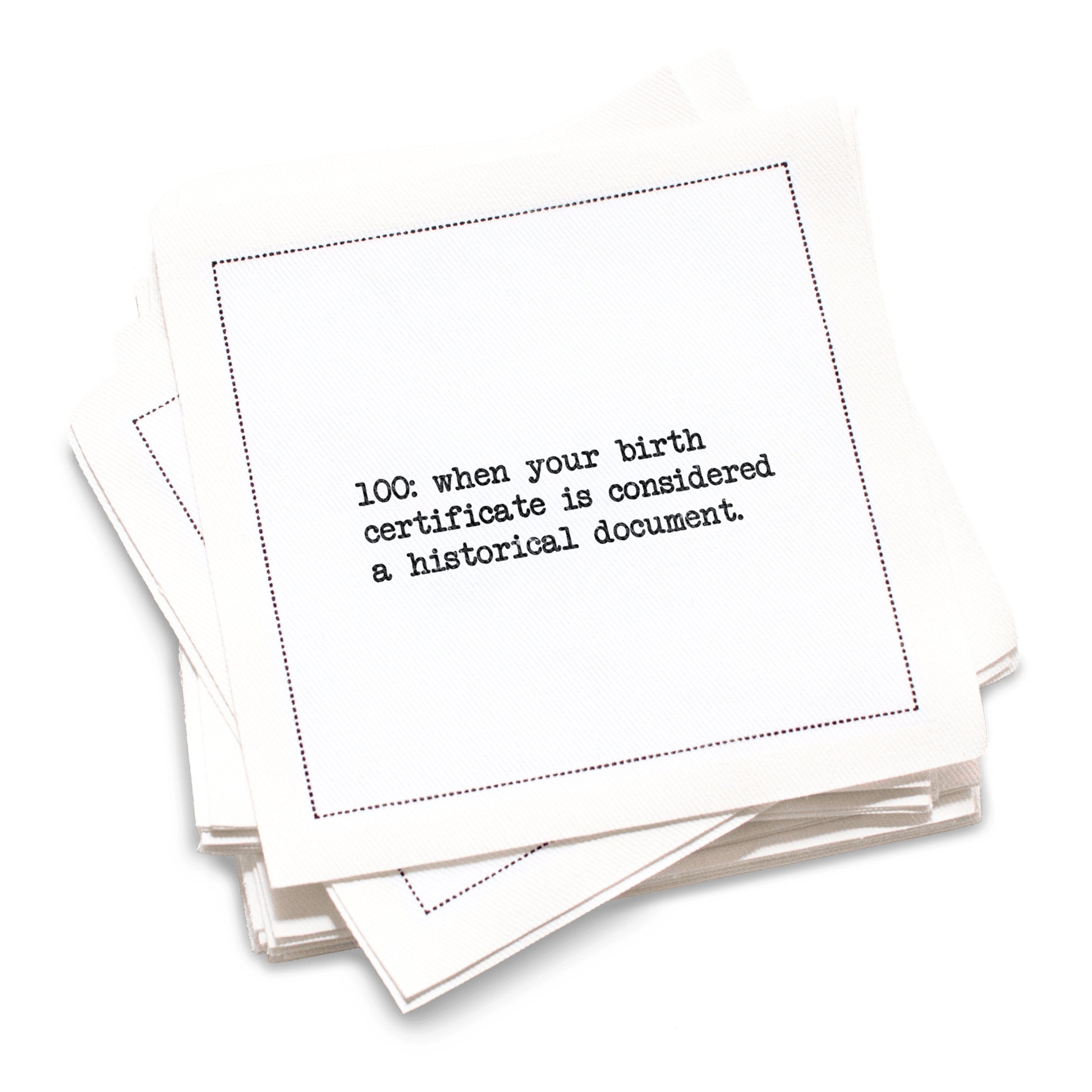 Organic cotton cocktail napkin with black dotted border printed with the quote "100: when your birth certificate is considered a historical document," from Five Star Napkins' 100th birthday quote collection