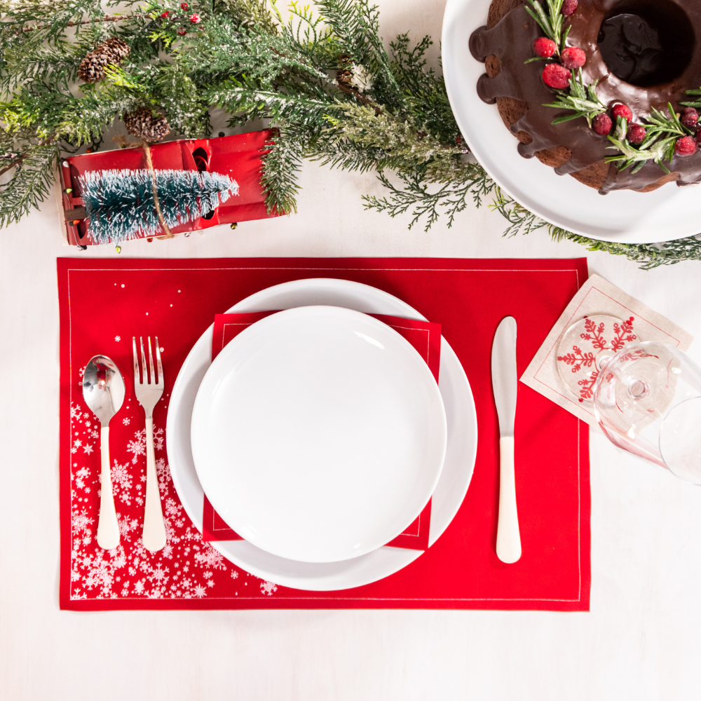 Holiday table setting with organic cotton Persimmon placemat and napkin, white snowflake print