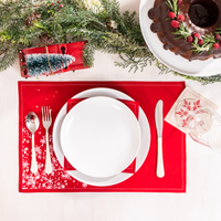 Holiday table setting with organic cotton Persimmon placemat and napkin, white snowflake print
