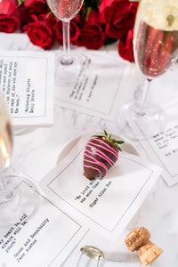 Organic cotton cocktail napkins with printed love quotes, champagne, roses, and a chocolate-covered strawberry