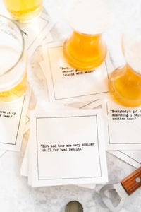 Organic cotton cocktail napkins with printed beer quotes, styled with beer glasses