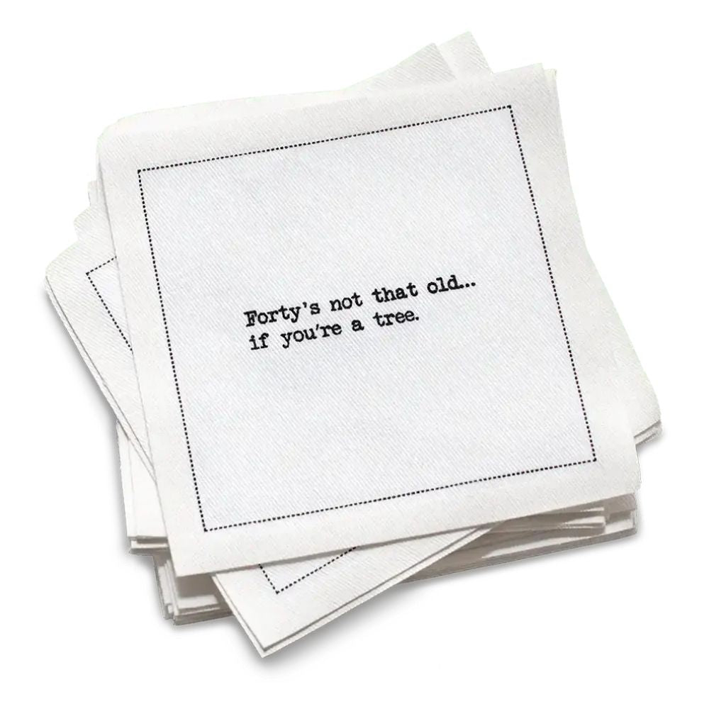 Organic cotton cocktail napkin with black dotted border printed with the quote "Forty's not that old... if you're a tree," from Five Star Napkins' 40th birthday quote collection