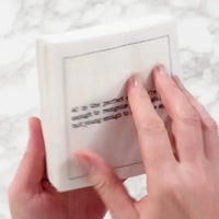 Video close-up of hands touching an organic cotton cocktail napkin printed with a 40th birthday quote, from Five Star Napkins' 40th Birthday Quotes collection