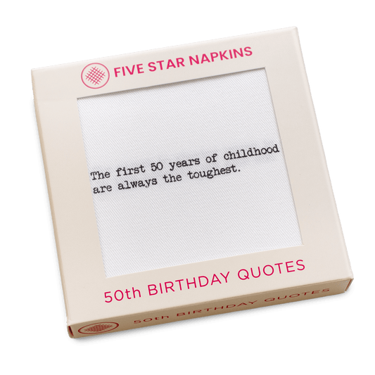 Kraft gift box from Five Star Napkins' 50th Birthday Quotes collection, showing an organic cotton cocktail napkin printed with the quote "The first 50 years of childhood are always the toughest"
