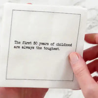 Video close-up of a hand touching an organic cotton cocktail napkin printed with a 50th birthday quote, from Five Star Napkins' 50th Birthday Quotes collection