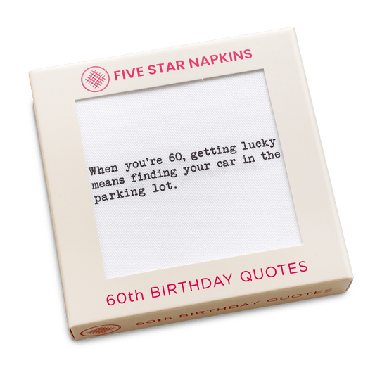 Kraft gift box from Five Star Napkins' 60th Birthday Quotes collection, showing an organic cotton cocktail napkin printed with the quote "When you're 60, getting lucky means finding your car in the parking lot"