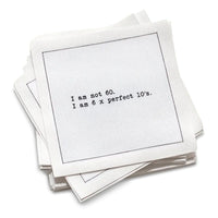 Organic cotton cocktail napkin with black dotted border printed with the quote "I am not 60. I am 6 x perfect 10's," from Five Star Napkins' 60th birthday quote collection