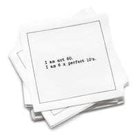 Organic cotton cocktail napkin with black dotted border printed with the quote "I am not 60. I am 6 x perfect 10's," from Five Star Napkins' 60th birthday quote collection
