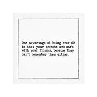 Organic cotton cocktail napkin with black dotted border printed with the quote "One advantage of being over 60 is that your secrets are safe with your friends, because they can't remember them either," from Five Star Napkins' 60th birthday quote collection