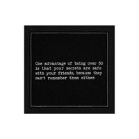 Organic cotton cocktail napkin, black, printed with the quote "One advantage of being over 60 is that your secrets are safe with your friends, because they can't remember them either," from Five Star Napkins' 60th birthday quote collection