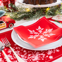 Persimmon organic cotton napkin with white snowflake pattern on a holiday table setting