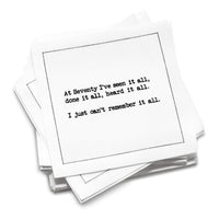 Stack of white organic cotton cocktail napkins with black dotted border printed with the quote “At Seventy I've seen it all, done it all, heard it all. I just can't remember it all,” from Five Star Napkins' 70th birthday quote collection