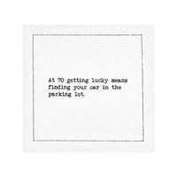 Organic cotton napkin with printed quote: At 70 getting lucky means finding your car in the parking lot.