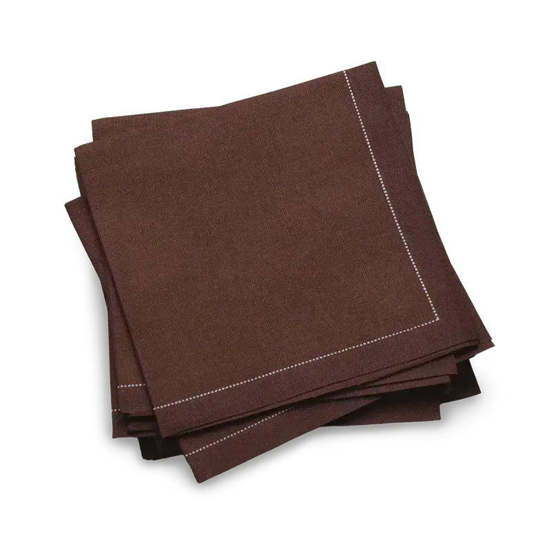Stack of brown organic cotton cocktail napkins with stitched edges, luxury table linen