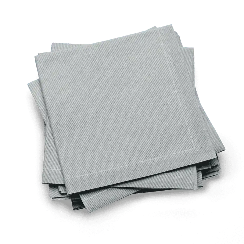 Set of pearl grey organic cotton cocktail napkins from Five Star Napkins on blue background