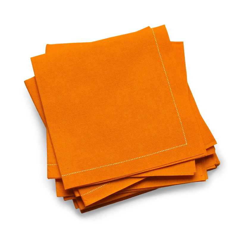 Stack of orange organic cotton luxury cocktail napkins from Five Star Napkins