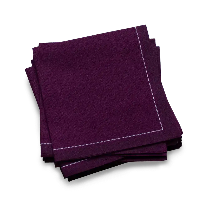 Luxury organic cotton cocktail napkin in deep purple, folded with stitched border