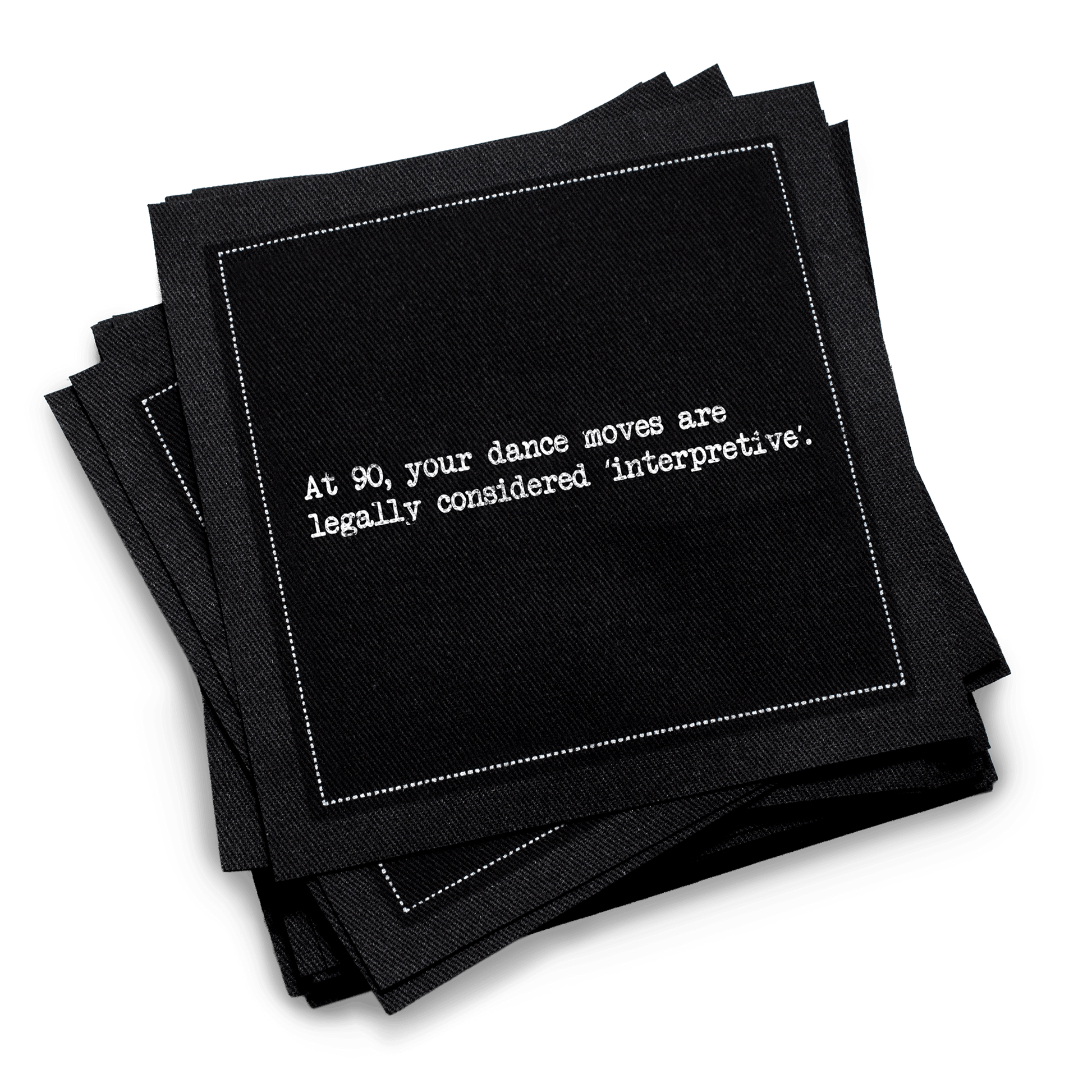 Organic cotton cocktail napkin, black, with white dotted border printed with the quote "At 90, your dance moves are legally considered 'interpretive,'" from Five Star Napkins' 90th birthday quote collection