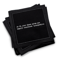 Organic cotton cocktail napkin, black, with white dotted border printed with the quote "At 90, your dance moves are legally considered 'interpretive,'" from Five Star Napkins' 90th birthday quote collection