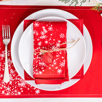 Organic cotton Persimmon napkin with white snowflake pattern on formal holiday place setting