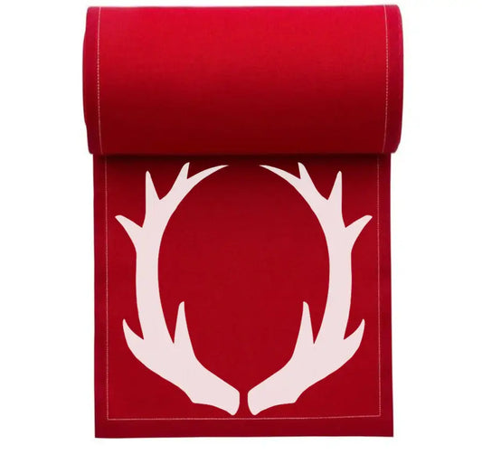 rolled organic cotton table runner in Toreador with white antler design