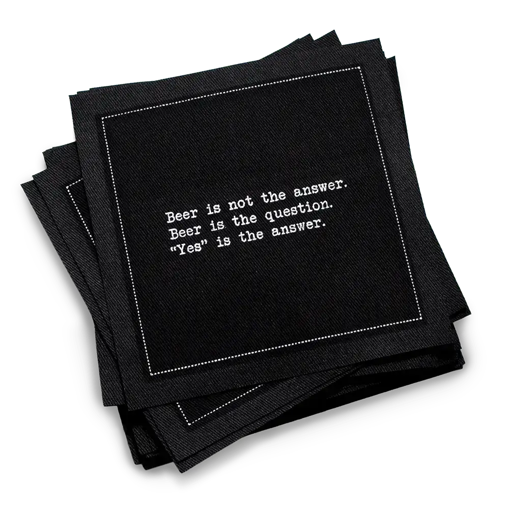 A stack of black Beer Quotes cocktail napkins printed with a white dotted border and the phrase, “Beer is not the answer. Beer is the question. ‘Yes’ is the answer.”