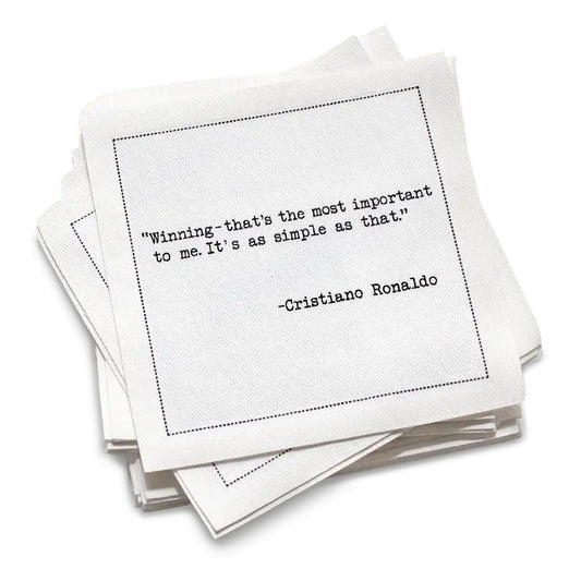 Stack of white cotton cocktail napkins with a black text quote by Cristiano Ronaldo on a white background