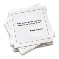 Stack of white cotton cocktail napkins with a black quote by Novak Djokovic on a white background