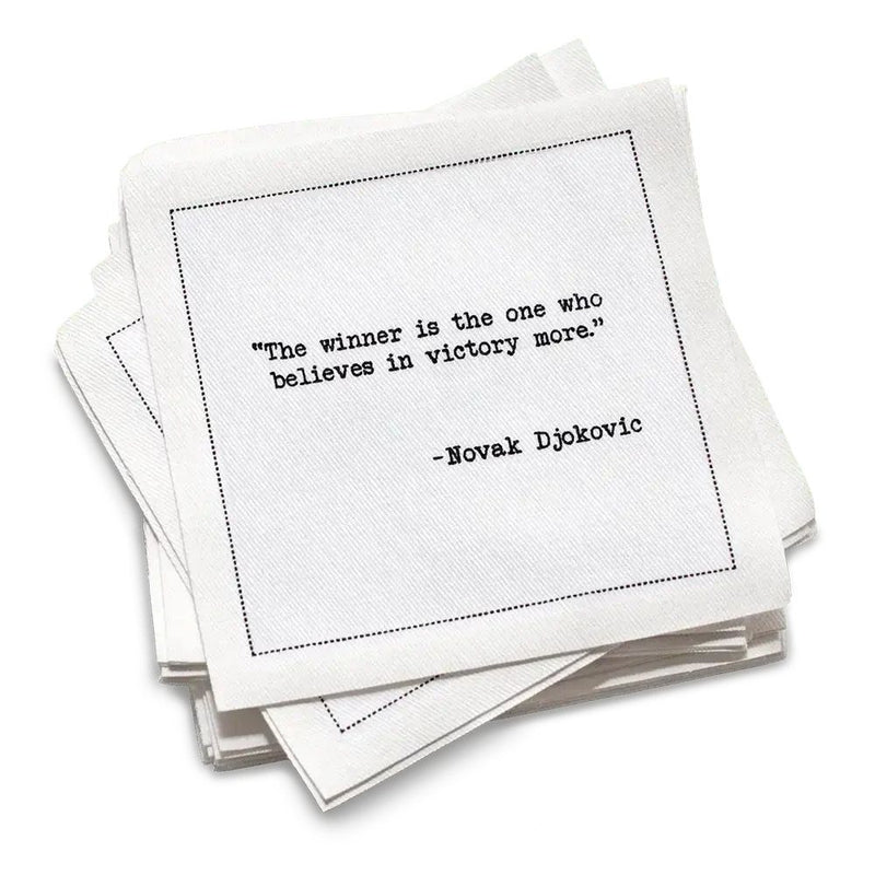 Stack of white cotton cocktail napkins with a black quote by Novak Djokovic on a white background