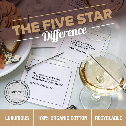 Luxury Five Star Napkins with cocktail quotes, cheese plate, and champagne glasses on table