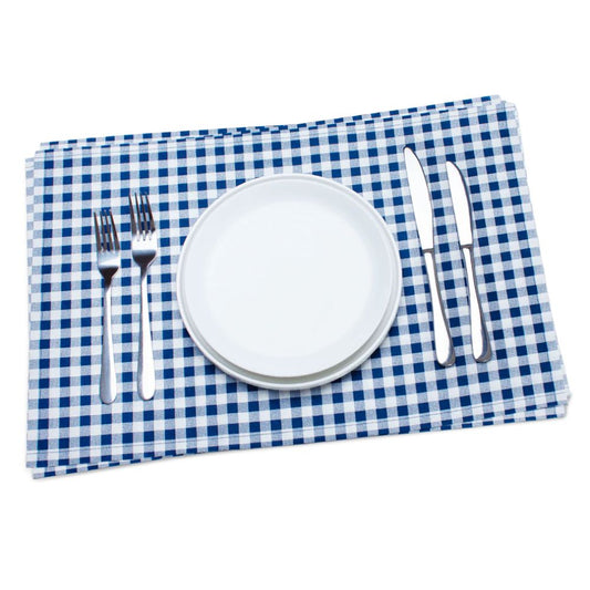 White plate with silverware on a blue and white checkered cotton placemat