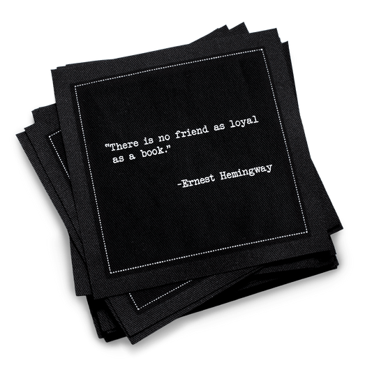 Organic cotton cocktail napkin, black, with white dotted border printed with the quote "There is no friend as loyal as a book," from Five Star Napkins' Book Club quote collection