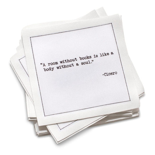 Organic cotton cocktail napkin, white, with black dotted border printed with the quote "There is no friend as loyal as a book," from Five Star Napkins' Book Club quote collection