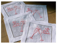 Set of organic cotton cocktail napkins with pink embroidered champagne glasses and quotes