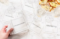 Organic cotton cocktail napkins with cat-themed printed quotes on a marble table setting.