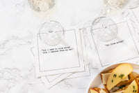Organic cotton cocktail napkins with cat-themed printed quotes at a table setting