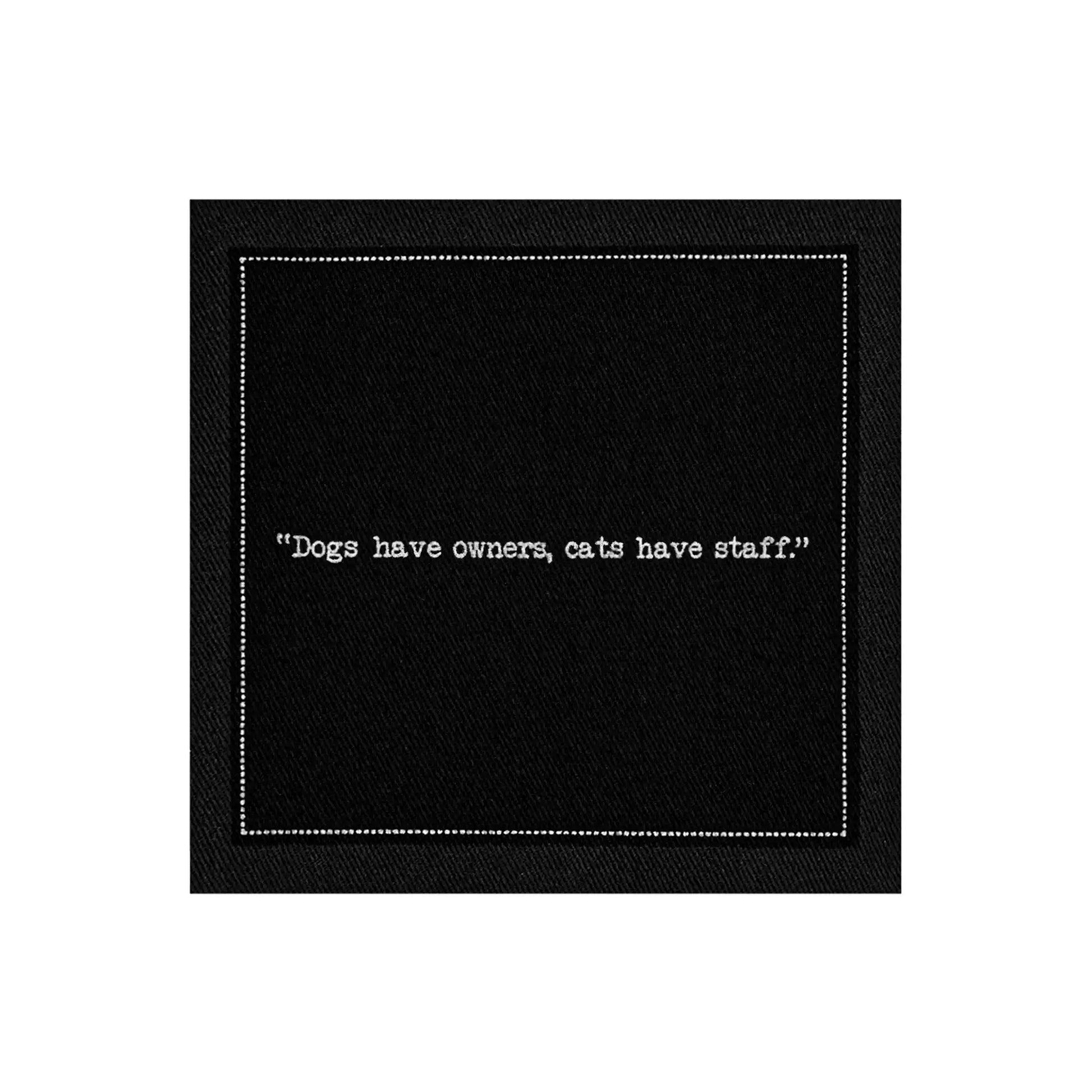 Anthracite Grey organic cotton napkin with printed quote 'Dogs have owners, cats have staff.'