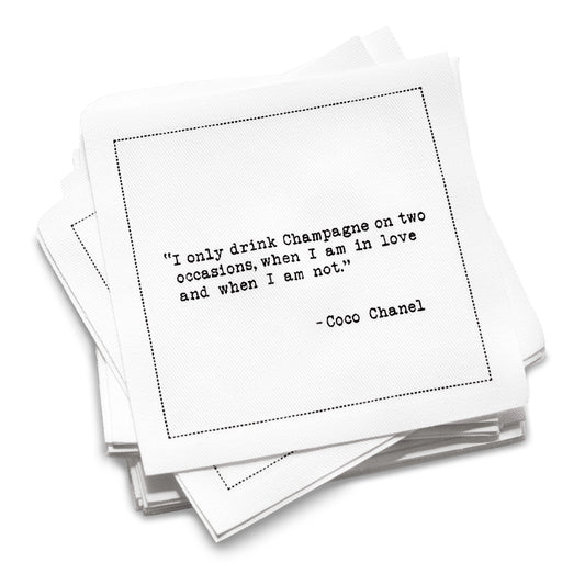 Organic cotton cocktail napkin with black dotted border printed with the Coco Chanel quote "I only drink Champagne on two occasions, when I am in love and when I am not," from Five Star Napkins' Champagne quote collection