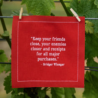 Christmas Red With White organic cotton napkin with Bridger Winegar quote pinned outdoors