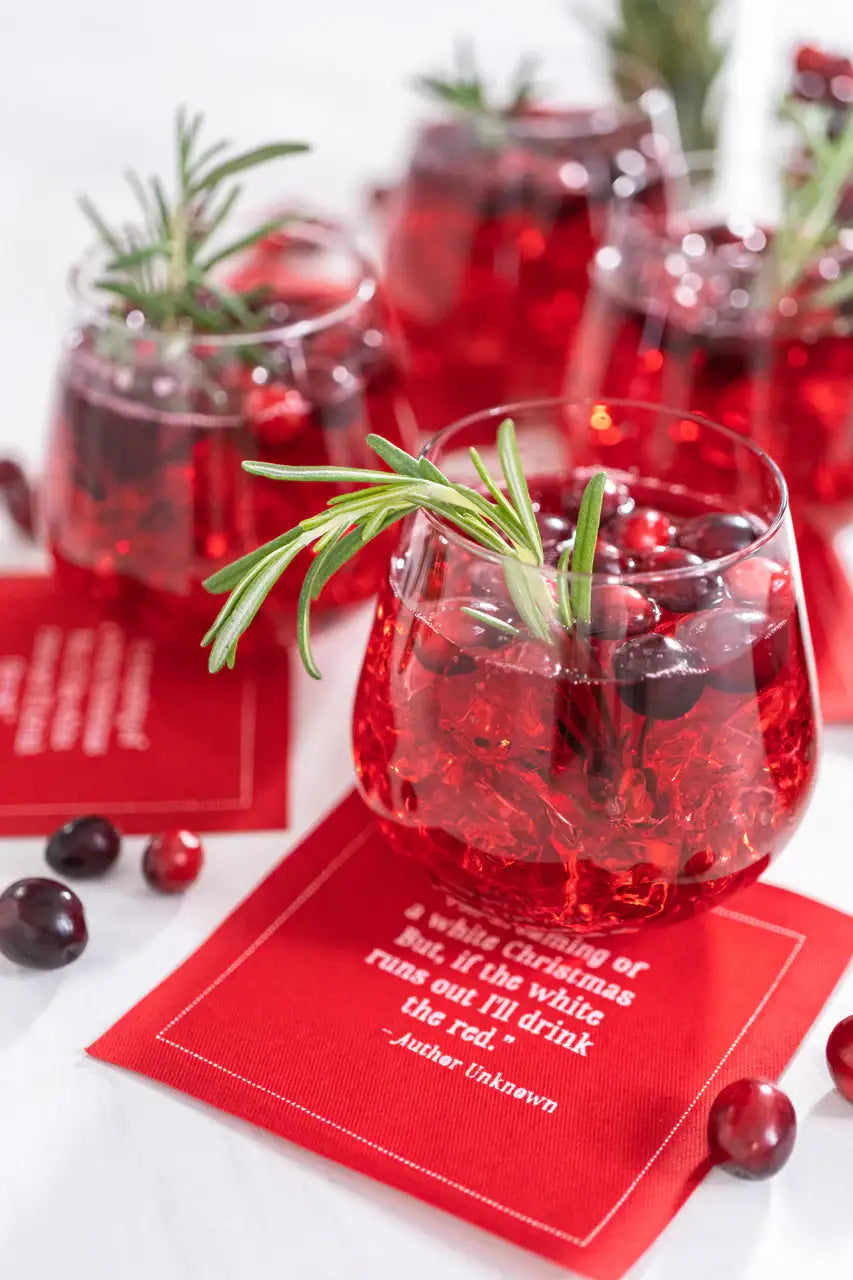 Anthracite Grey organic cotton cocktail napkin with printed quote, red holiday drink, rosemary garnish, berries, styled for a cocktail party