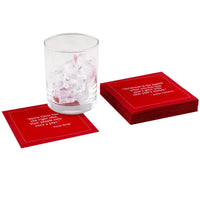 Toreador organic cotton cocktail napkins with white printed holiday quotes, glass of ice on one napkin