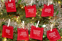 Persimmon organic cotton napkins with Christmas quotes displayed on a decorated tree
