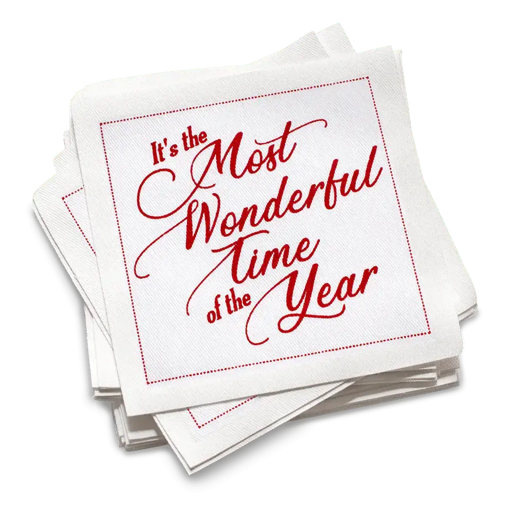 Stack of white organic cotton cocktail napkins printed with “It’s the Most Wonderful Time of the Year” in red script, by Five Star Napkins.