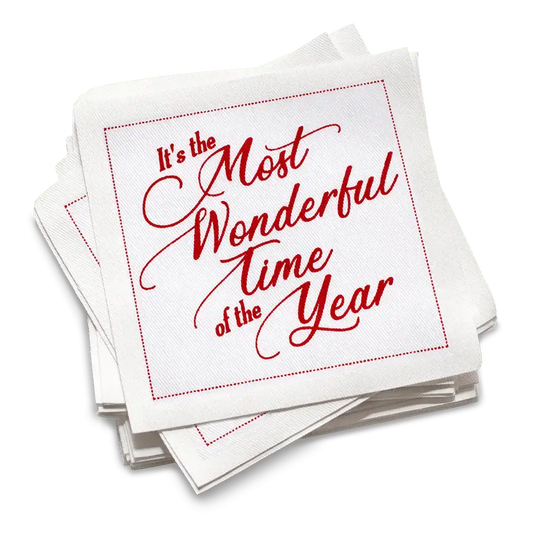 Stack of white organic cotton cocktail napkins printed with “It’s the Most Wonderful Time of the Year” in red script, by Five Star Napkins.