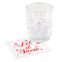 Organic cotton cocktail napkin with red 'Let it Snow' quote next to glass with ice