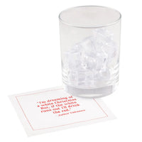White organic cotton cocktail napkin with red printed quote, under glass with ice cubes