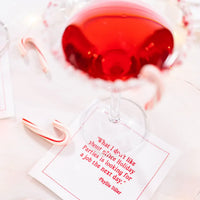 Organic cotton cocktail napkin with red quote, candy canes, and cocktail glass at a holiday setting