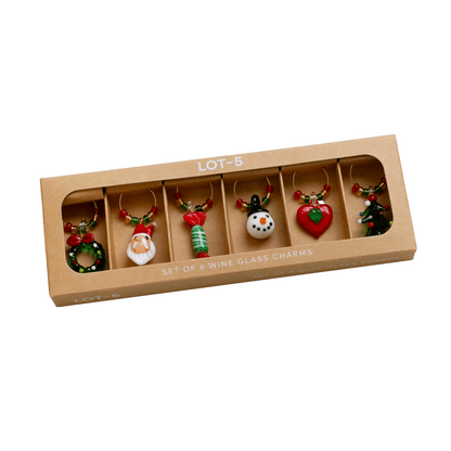 Set of 5 Christmas-themed wine glass charms in a cardboard box on a white background