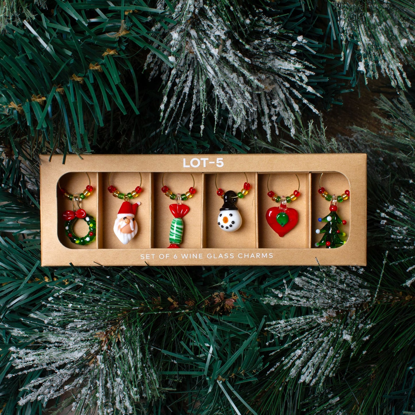 Set of 6 wine glass charms on a Christmas tree background