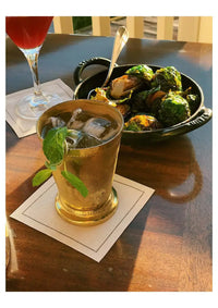 White organic cotton cocktail napkins under drinks at a table setting with food